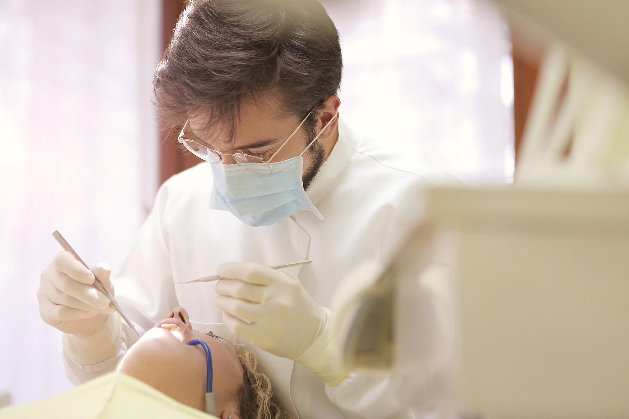 A dentist cleaning a patient's teeth