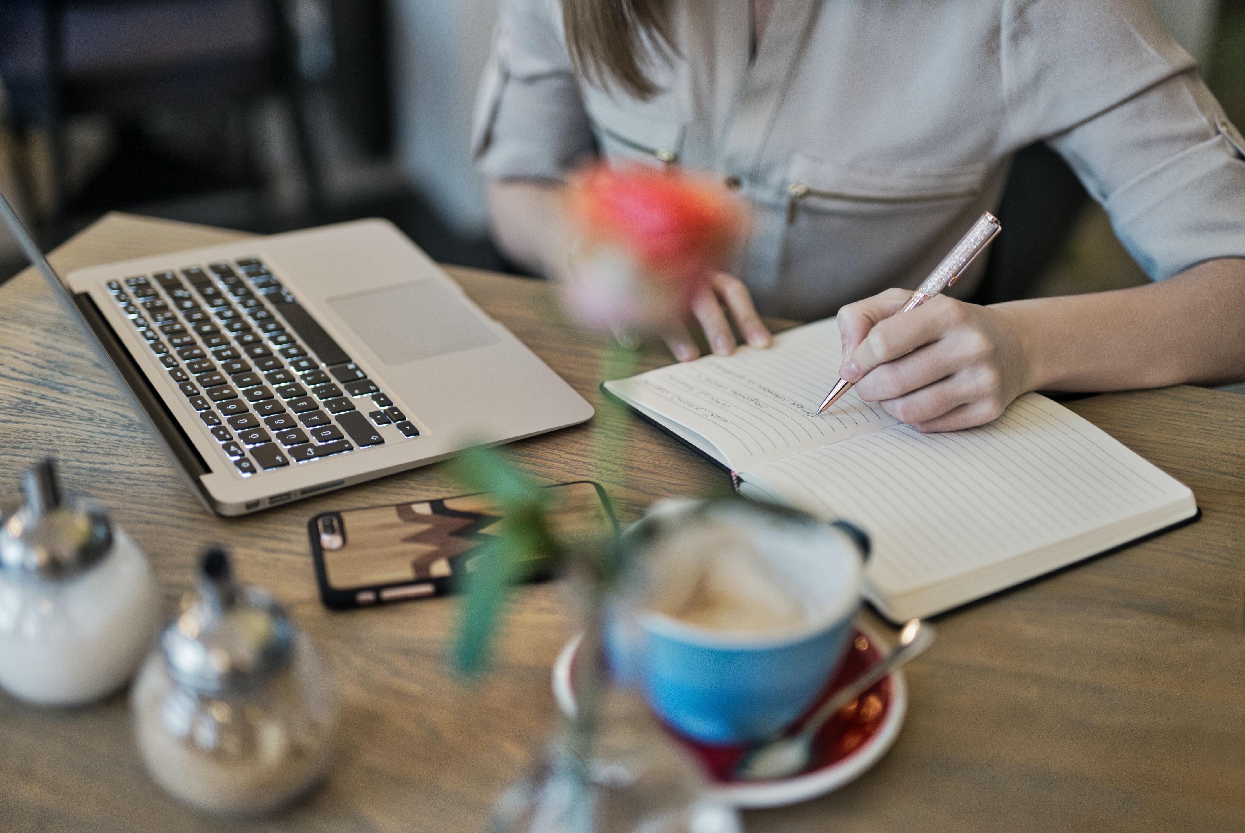 student studying with a laptop and cup of coffee