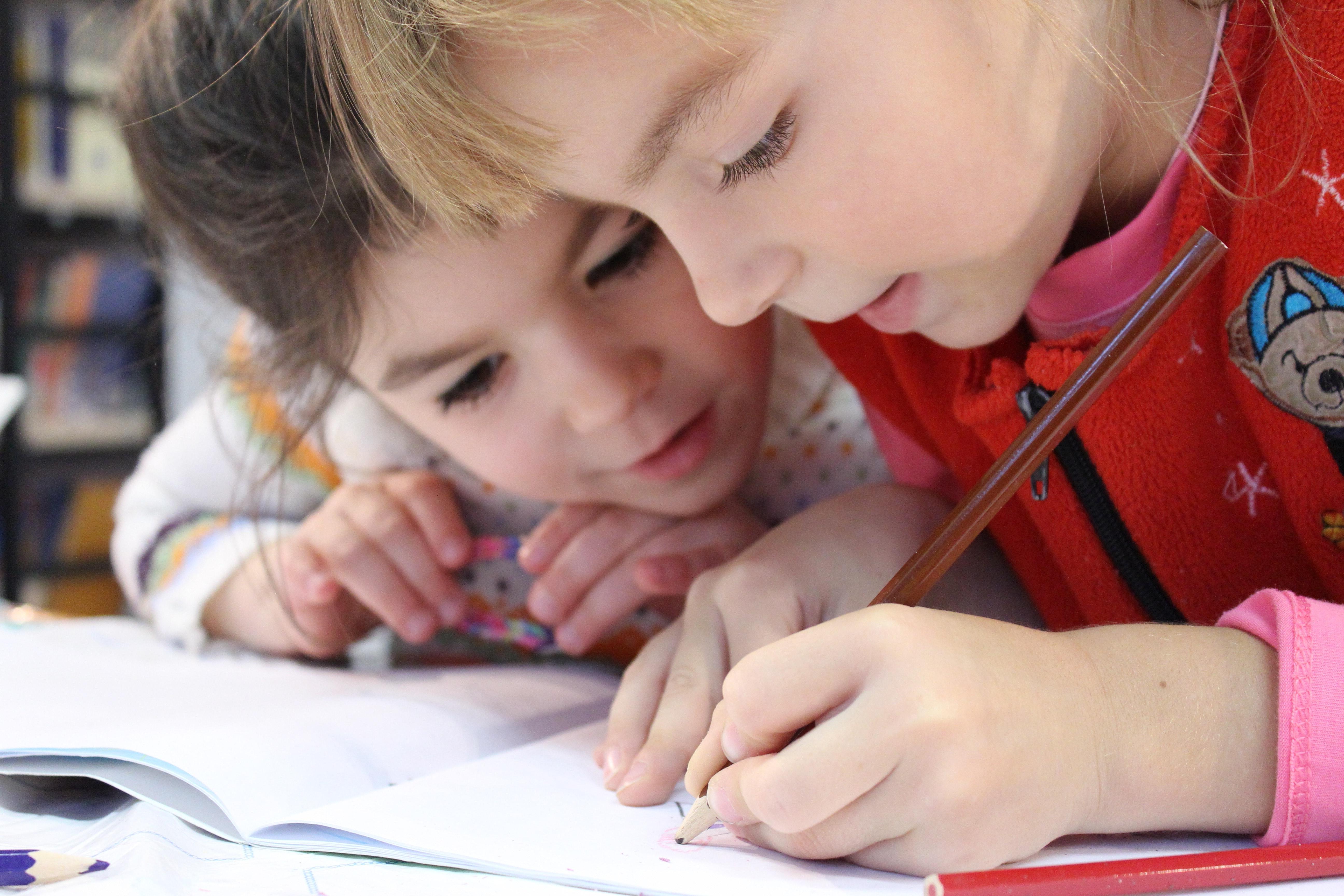 Two small children working together on their homework