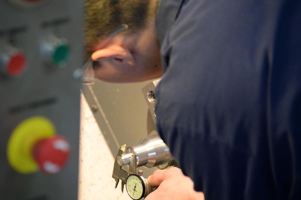 A student checking the pressure of a continer